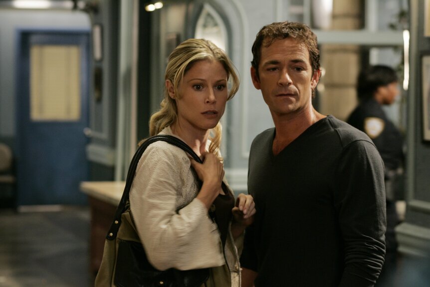 Gwen Sibert (Julie Bowen) and Noah Sibert (Luke Perry) stand in a police station on Law & Order: Special Victims Unit Episode 1002.