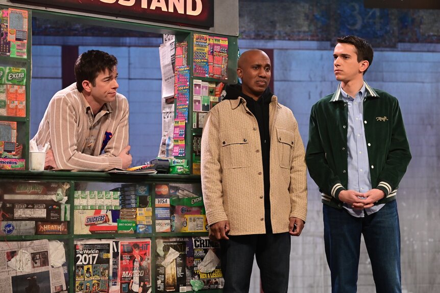 John Mulaney hangs out of a bodega stand and talks to Chris Redd and Andrew Dismukes on Saturday Night Live Episode 1818.