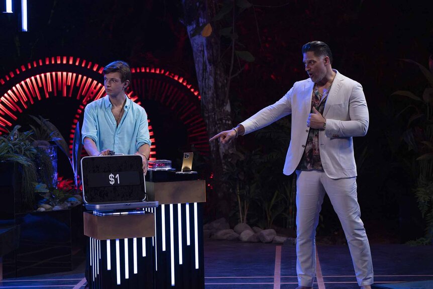 Joe Manganiello points to a $1 briefcase on Deal or No Deal Island Episode 201.