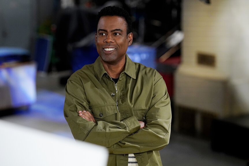 Chris Rock stands with his arms crossed in studio 8H for promos for Saturday Night Live Season 50 Episode 9