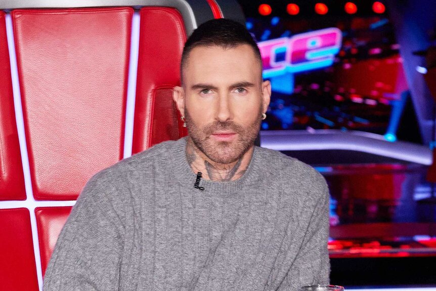 Adam Levine smiling in the coaches chair on The Voice Season 27, Episode 1.