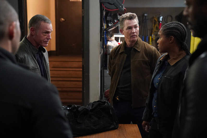 Hank Voight and Chief Reid stand in an apartment on Chicago P.D. Season 12 Episode 9