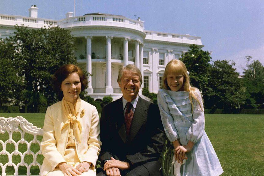 Rosalynn Carter, Jimmy Carter, and Amy Carter pose on the south lawn in front of the White House, circa 24 July 1977.