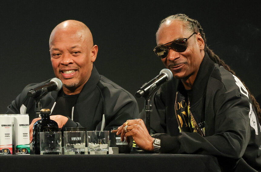 Dr. Dre and Snoop Dogg participate in a podcast recording.