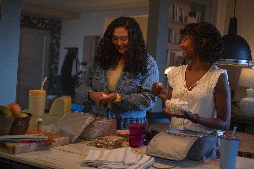 Dr. Dana Dang (Aury Krebs) and Dr. Ericka Kinney (Ashleigh LaThrop) pack lunchboxes together on Brilliant Minds Episode 113.