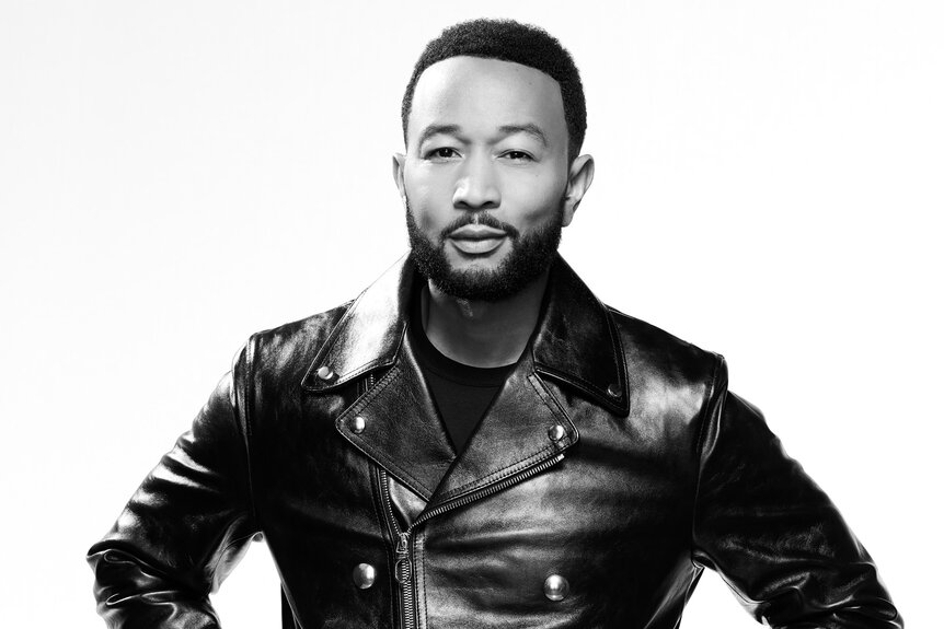 John Legend wears a leather jacket and poses for The Voice Season 27