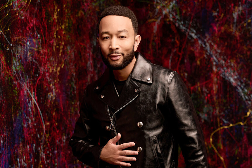 John Legend wears a leather jacket and poses for The Voice Season 27